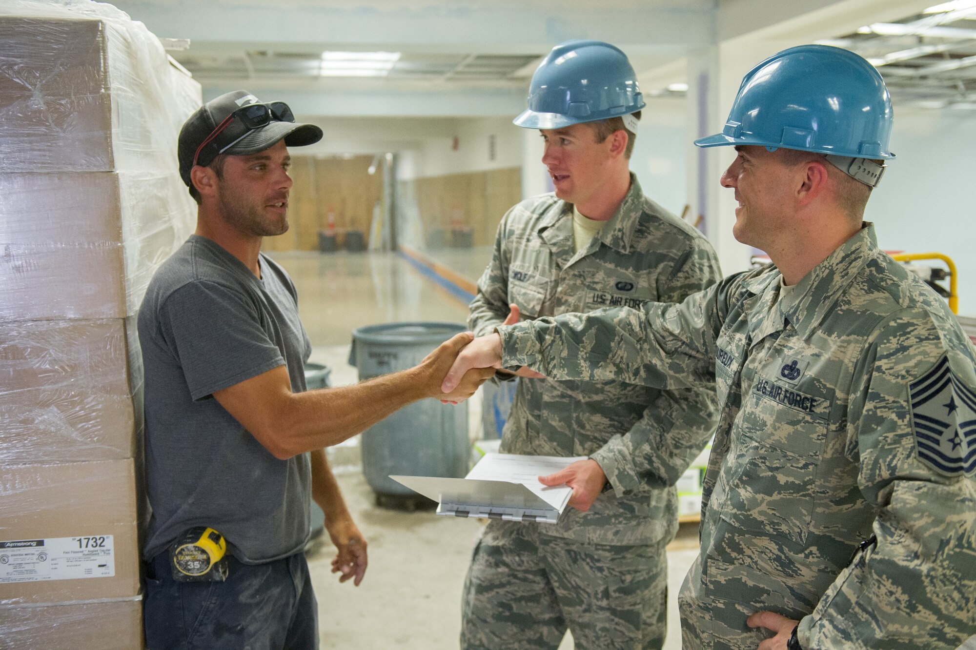 Chief Master Sgt. Jason Lamoureux, far right, 45th Space Wing command chief, shadows Airman First Class Alexander Wolf, contracting officer, and meets with Robert Plemmons II, a contracted carpenter during a site visit at the Patrick Air Force Base fitness center May 25, 2016. Observing the contracted work to renovate the weight room was part of the chief’s visit to the 45th Contracting Squadron. The wing commander and command chief visit with 45th SW members each month in order to gain a better understanding of the jobs their Airmen do daily, address their questions and concerns and look for ways they can provide additional support. (U.S. Air Force photo by Benjamin Thacker/released)