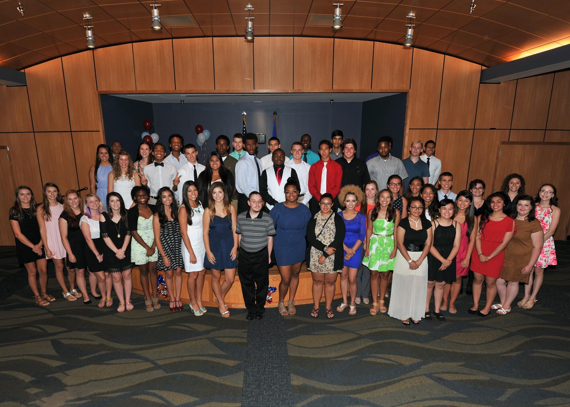 Dependents of military service members pose for a photo during the Military High School Graduation Recognition Ceremony, May 19, at the Horizons Community Center. The ceremony honored the children of military members who experience frequent moves during their school years and celebrated their resiliency and accomplishments. (U.S. Air Force photo by Senior Airman Ty-Rico Lea/Released)