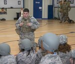 Tech. Sgt. Matthew Phillips, 502nd Security Forces Squadron military working dog handler, speaks with school students during Operation Flags May 18 at Randolph Elementary School. Phillips spoke about what a working dog is trained to do during home and deployed operations. 