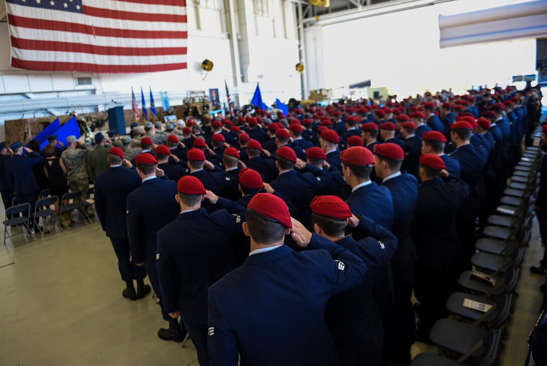 Airmen salute during Capt. Matthew D. Roland and Staff Sgt. Forrest B. Sibley’s memorial service, Sept. 14, 2015, at Hurlburt Field, Fla. More than 1000 friends and family members from across the country gathered together to mourn the loss of Capt. Matthew Roland, a special tactics officer from 23rd Special Tactics Squadron, and Staff Sgt. Forrest Sibley, a combat controller from the 21st Special Tactics Squadron, at the Freedom Hangar on Hurlburt Field, Fla., Sep. 14, 2015. The two Special Tactics Airmen, who had recently deployed to Afghanistan in support of Operation Freedom's Sentinel, were shot at a vehicle checkpoint at Camp   Antonik, Afghanistan, Aug. 26, and died of wounds sustained in the attack, were honored in a private memorial.  Both Special Tactics Airmen will be buried with full military honors.(U.S. Air Force photo by Senior Airman Ryan Conroy/Released) 

