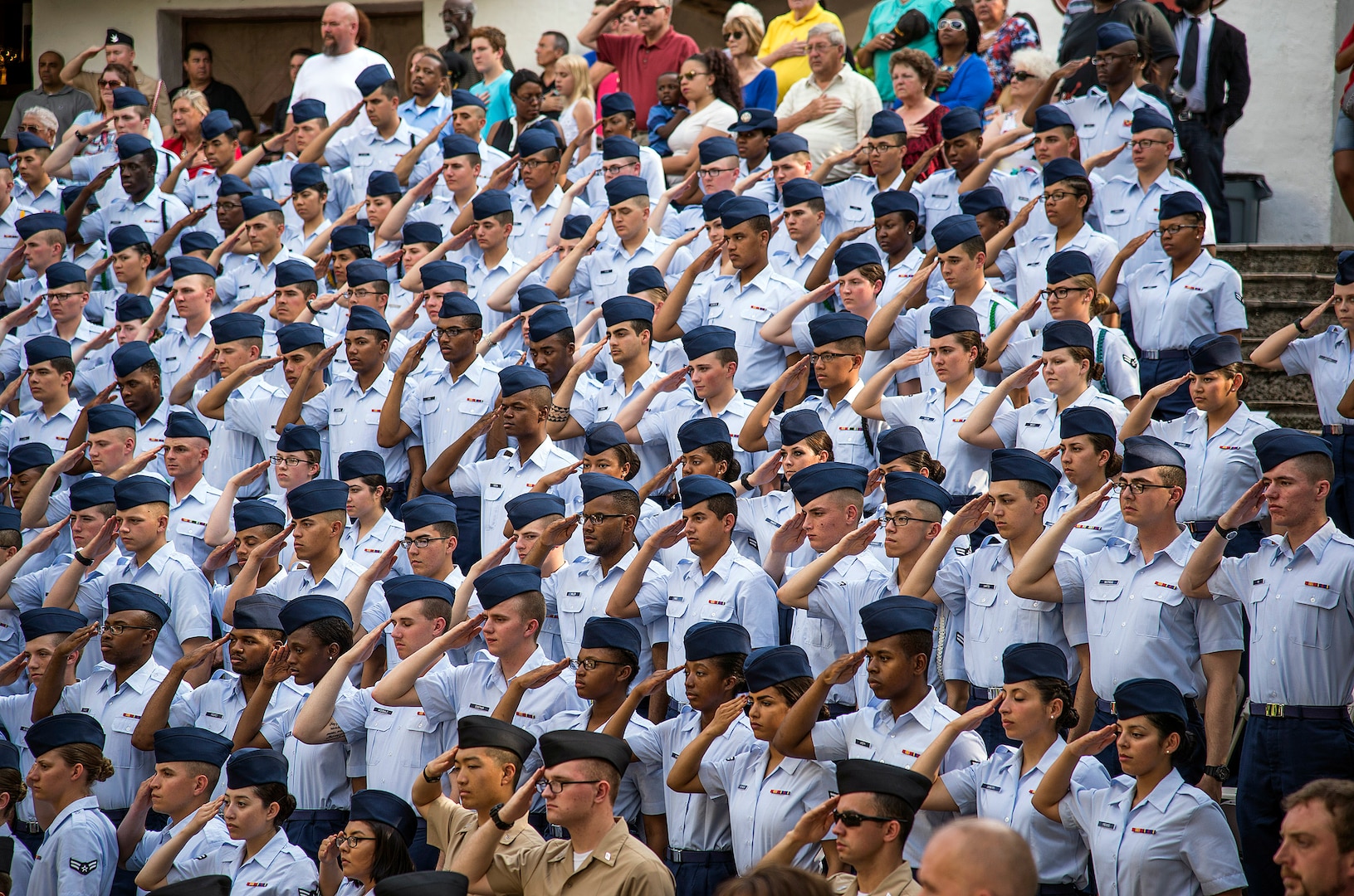 Military members render salutes while civilians hold their hands over their hearts as the U.S. Army North’s 323rd Army Band, “Fort Sam’s Own,” plays the Marines’ Hymn during the Armed Forces River Parade May 21 at the San Antonio Riverwalk. To kick-start the parade, the band played each services’ song along with the National Anthem. (U.S. Air Force photo by Johnny Saldivar/RELEASED)