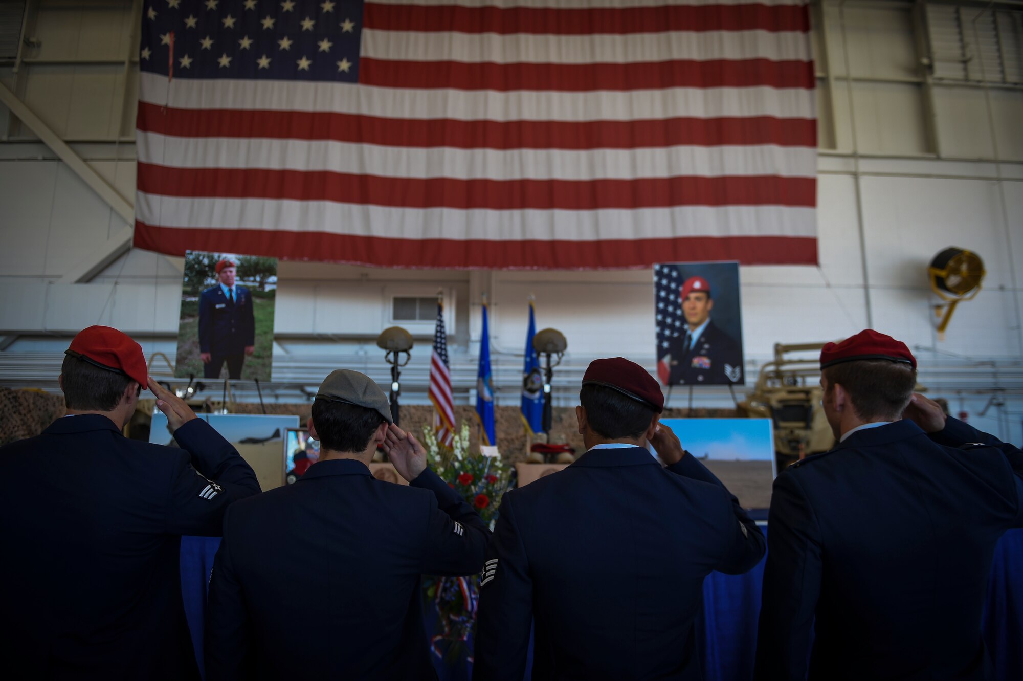 Airmen salute during Capt. Matthew D. Roland and Staff Sgt. Forrest B. Sibley’s memorial service,Sept. 14, 2015, at Hurlburt Field, Fla. More than 1000 friends and family members from across the country gathered together to mourn the loss of Capt. Matthew Roland, a special tactics officer from 23rd Special Tactics Squadron, and Staff Sgt. Forrest Sibley, a combat controller from the 21st Special Tactics Squadron, at the Freedom Hangar on Hurlburt Field, Fla., Sep. 14, 2015. The two Special Tactics Airmen, who had recently deployed to Afghanistan in support of Operation Freedom's Sentinel, were shot at a vehicle checkpoint at Camp   Antonik, Afghanistan, Aug. 26, and died of wounds sustained in the attack, were honored in a private memorial.  Both Special Tactics Airmen will be buried with full military honors. (U.S. Air Force photo by Senior Airman Ryan Conroy/Released) 