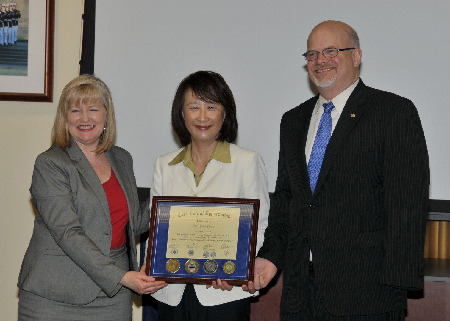 Grace Spence (center) is presented a certificate of appreciation by Maureen Higgins and Philip Hepperle, both of the Defense Contract Audit Agency, May 25, 2016. 