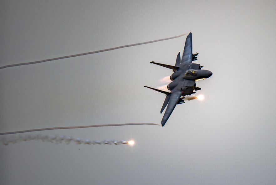 An F-15E Strike Eagle fires flares over the Grand Bay Bombing and Gunnery Range at Moody Air Force Base, Ga., May 20, 2016. During the training, Air Combat Command aircraft conducted tactical air and ground maneuvers, as well as weapons training. (U.S. Air Force photo by Tech. Sgt. Zachary Wolf/Released)
