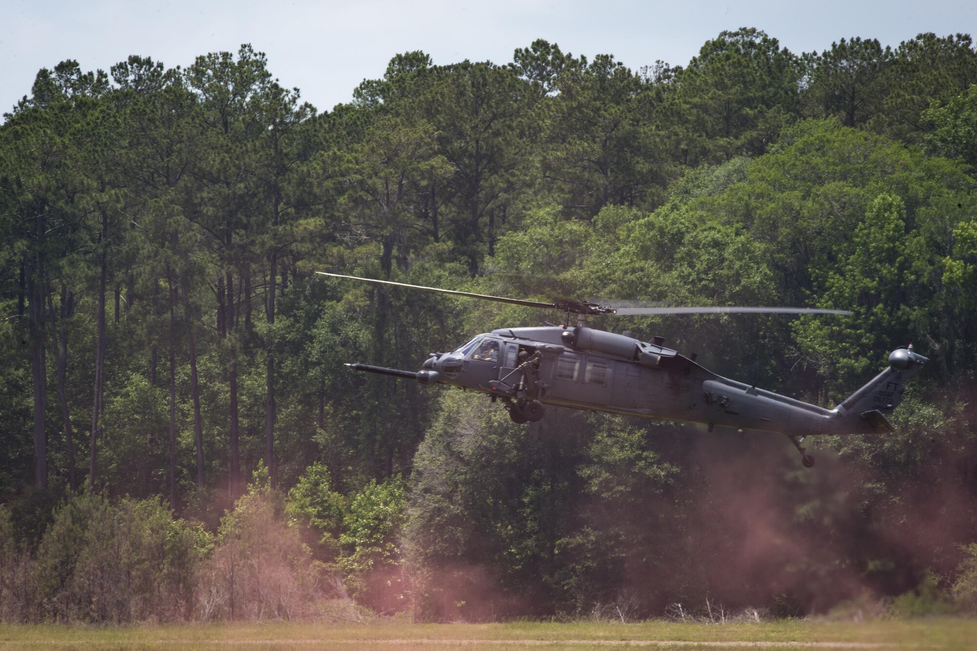 An HH-60G Pave Hawk descends to land on Grand Bay Bombing and Gunnery Range at Moody Air Force Base, Ga., May 19, 2016. The Pave Hawk participated in training simulating different combat situations to synchronize efforts between a variety of Air Combat Command airframes. (U.S. Air Force photo by Airman Daniel Snider/Released)