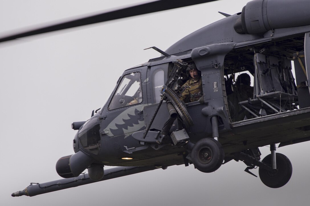 A special missions aviator from the 41st Rescue Squadron looks out from an HH-60G Pave Hawk over Grand Bay Bombing and Gunnery Range at Moody Air Force Base, Ga., May 20, 2016. Airmen simulated different combat and rescue situations to synchronize efforts between a variety of Air Combat Command airframes. (U.S. Air Force photo by Airman Daniel Snider/Released)