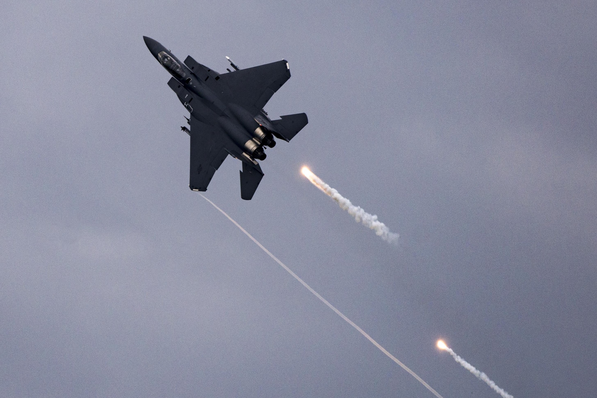 An F-15E Strike Eagle fires flares over Grand Bay Bombing and Gunnery Range at Moody Air Force Base, Ga., May 20, 2016. Airmen simulated different combat and rescue situations to synchronize efforts between a variety of Air Combat Command airframes. (U.S. Air Force photo by Airman Daniel Snider/Released)

