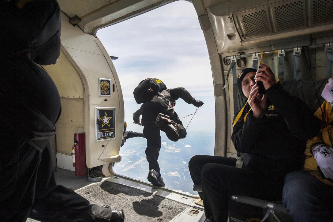 A member of the Golden Knights, the Army's parachute demonstration team, jumps out the side door of a C-31A aircraft during an air show and open house at Joint Base McGuire-Dix-Lakehurst, N.J., May 14, 2016. Air Force photo by Senior Airman Joshua King