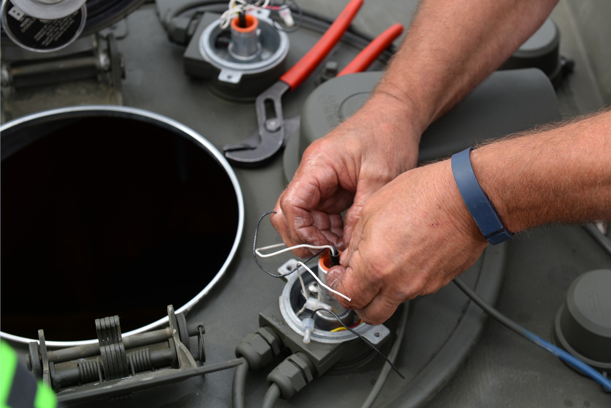 Joe Robinson, 4th Logistics Readiness Squadron fire truck and refueling maintenance technician, adjusts a fuel sensor on the new Isometrics R-11 Refueler, May 17, 2016, at Seymour Johnson Air Force Base, North Carolina. The new R-11 has more automatic features to help prevent fuel waste and accidents. (U.S. Air Force photo by Airman 1st Class Ashley Williamson)