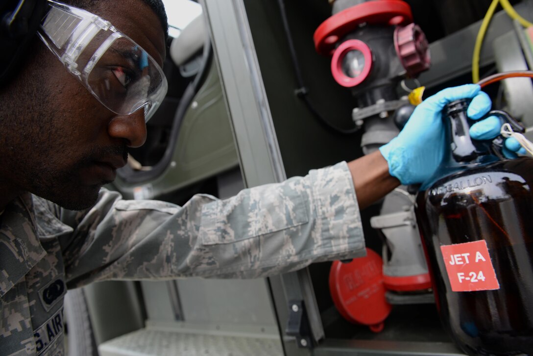 Senior Airman Terrence Baker, 4th Logistics Readiness Squadron petroleum, oil, and lubricants fuels lab technician, takes fuel samples from the new Isometrics R-11 Refueler, May 17, 2016, at Seymour Johnson Air Force Base, North Carolina. The R-11 has the ability to carry fuel to jets and pump fuel from underground hydrant systems to refuel aircraft. (U.S. Air Force photo by Airman 1st Class Ashley Williamson)