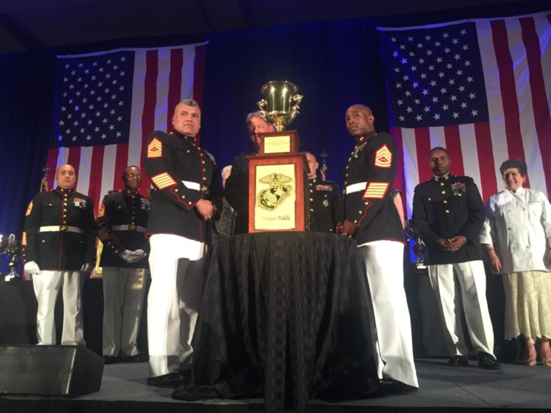Master Sgt. Johnny Sandoval, food service technician and staff noncommissioned officer in charge of Gonzales Hall, Marine Corps Air Station Miramar, California, and Gunnery Sgt. Antwan Macon, mess hall liaison and operations chief of Gonzales Hall, accept Maj. Gen. W.P.T. Hill Award for Food Service Excellence competition for the best chow hall in the Marine Corps at the Charlton Hotel in Chicago, Illinois, May 20. 