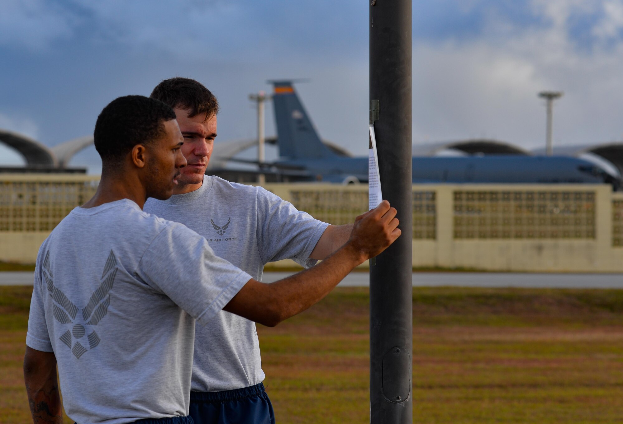 Senior Airman Damien Baker, left, and Airman 1st Class Albert White, 36th Comptroller Squadron financial services technicians,  read the story of a holocaust victim during a rememberance walk May 26, 2016, at Andersen Air Force Base, Guam. Andersen Airmen remembered the tragedy of the holocaust during an 11-hour vigil walk  past the names and stories of  individuals and families who suffered under the Nazi regime in Germany from 1933-1945. (U.S. Air Force photo by Staff Sgt. Alexander W. Riedel/Released)