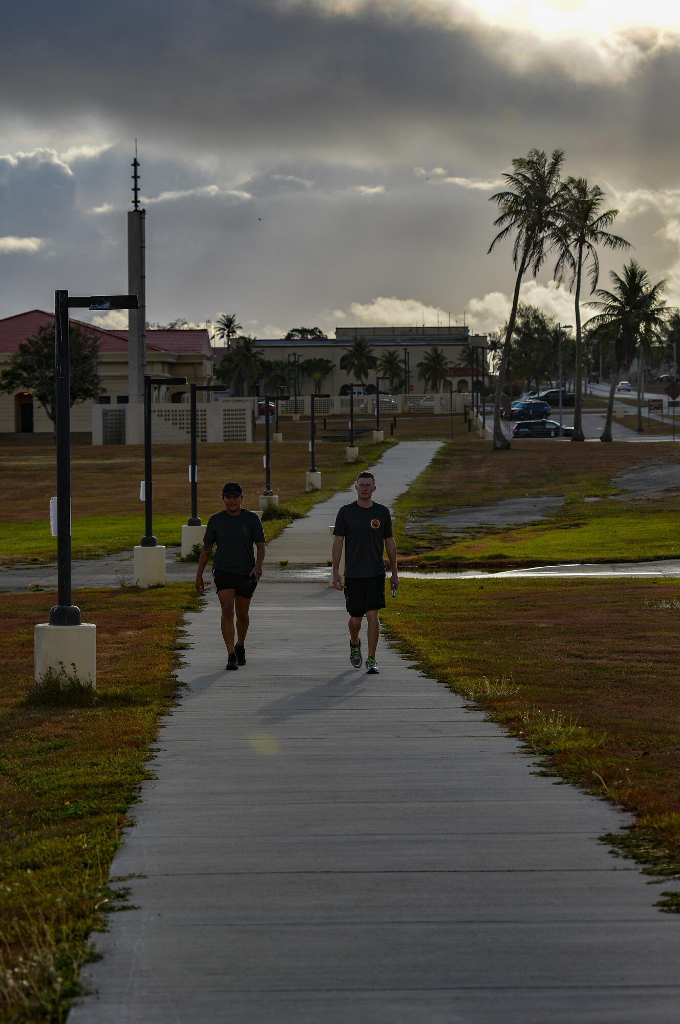 Staff Sgt. Collin Wanberg, right,  and Airman 1st Class Jasmine Mora, walk with a rememberance baton during the Holocaust Memorial Walk May 26, 2016, at Andersen Air Force Base, Guam. Team Andersen commemorated the the victims of the holocaust with an 11-hour vigil walk past the names and stories of victims. Wanberg and Mora are with the 36th Munitions Squadron. (U.S. Air Force photo by Staff Sgt. Alexander W. Riedel/Released)