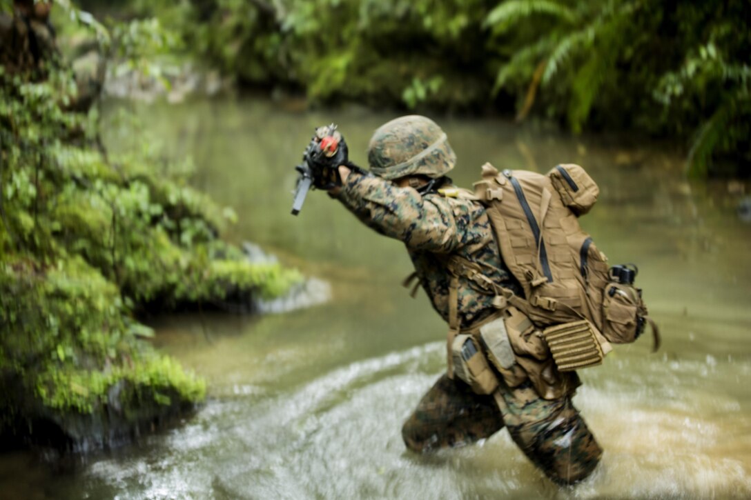 U.S. Marine Pfc. Henry D. Yandell lands in the creek after rappelling off a mountain May 19, 2016 at the Jungle Warfare Training Center, Camp Gonsalves, Okinawa, Japan. Yandell is a combat engineer with 9th Engineer Support Battalion, 3rd Marine Logistics Group, III Marine Expeditionary Force. Yandell and his platoon attended the 5-day Course at JWTC. The course gives Marines the skills to shoot, move and communicate within a jungle environment. (U.S. Marine Corps photo by Lance Cpl. Amaia Unanue/ Released)
