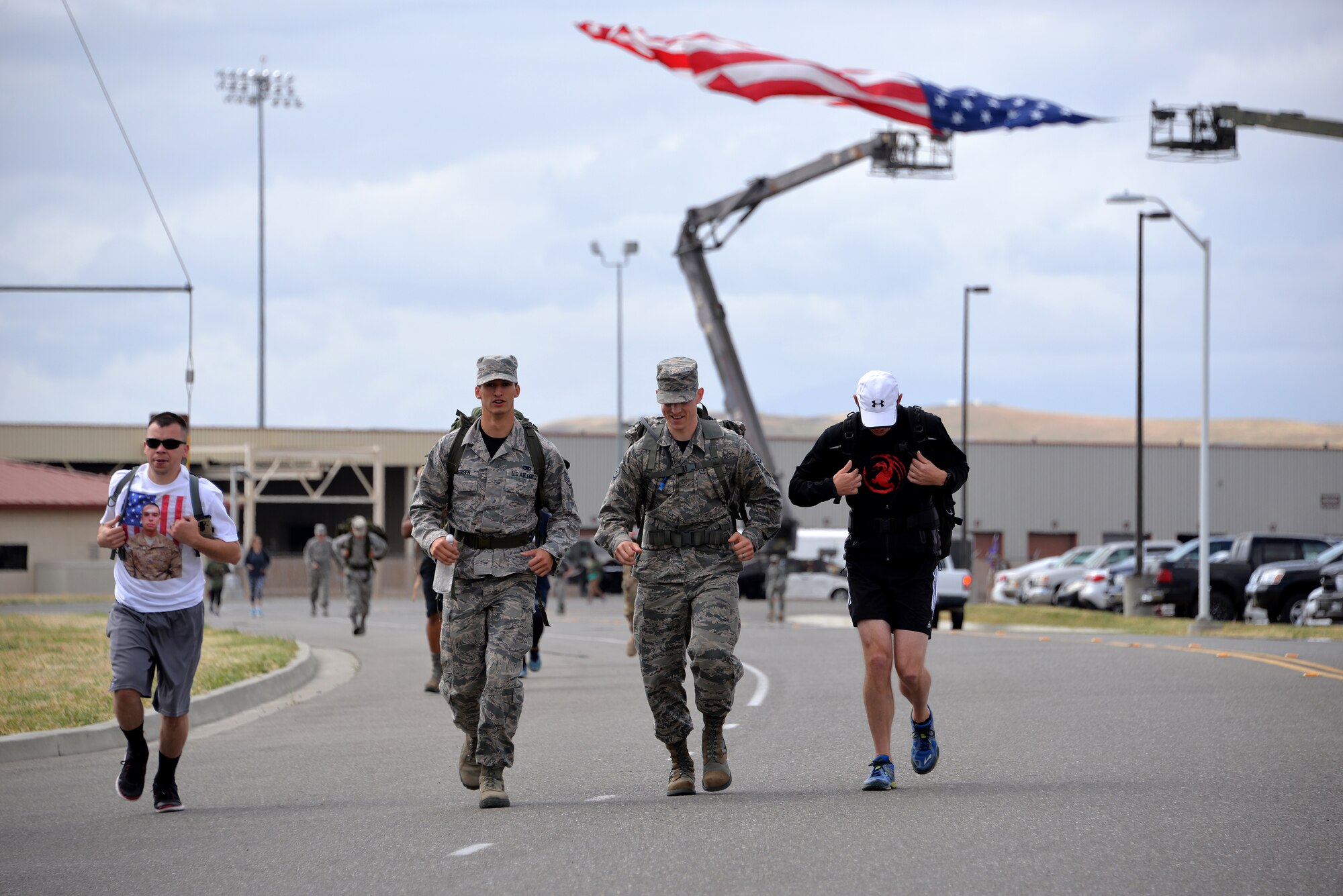 Airmen carry a 30-pound rucksack during the Gold Star Families Ruck March at Travis Air Force Base, Calif., May 21, 2016. Approximately 200 service members participated in the sixth annual GSFRM, honoring the more than 45 Gold Star family members who were in attendance. (U.S. Air Force photo by Staff Sgt. Charles Rivezzo)