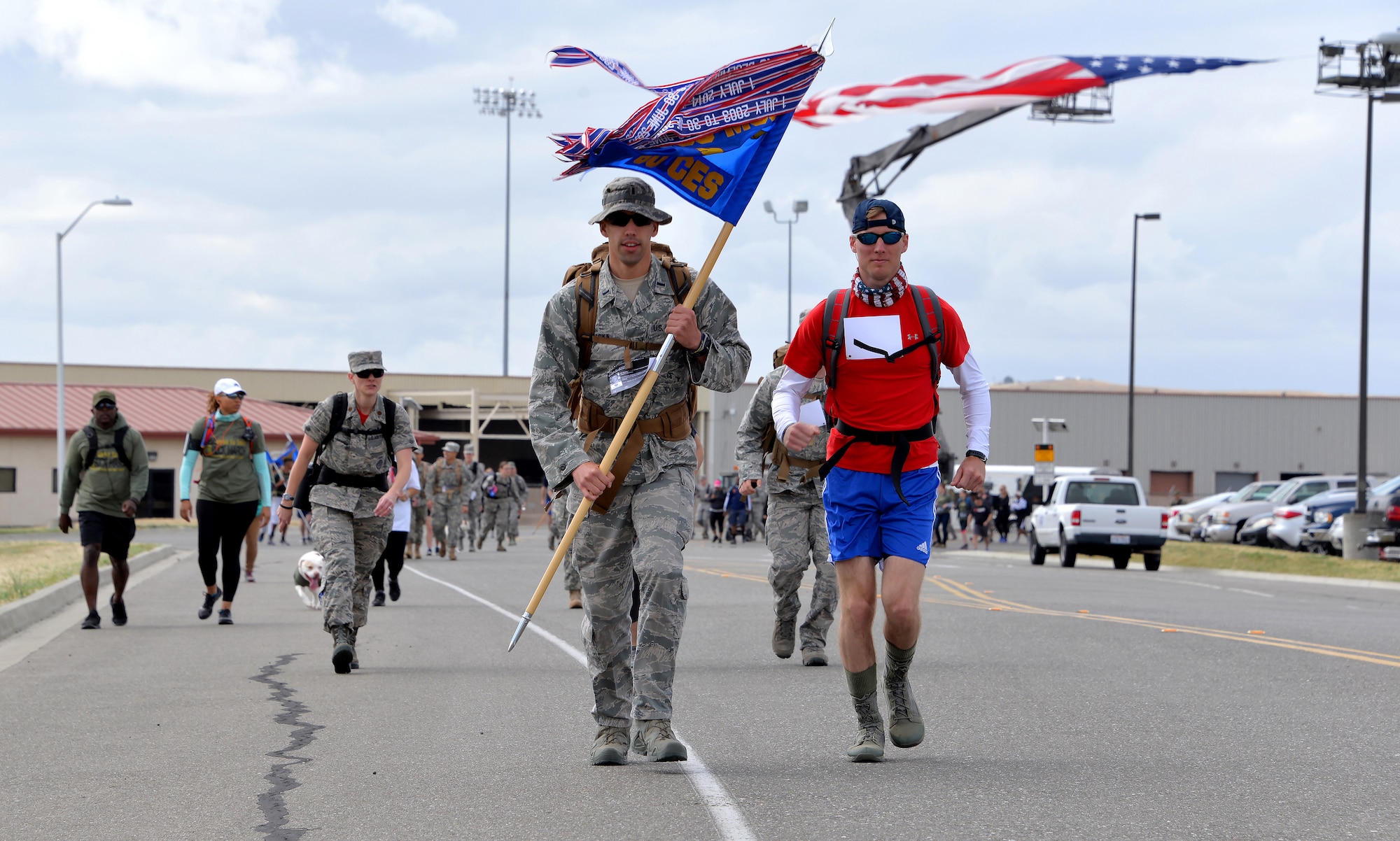 1st Lt. Derek Raska, 60th Civil Engineer Squadron deputy flight chief readiness and emergency management, carries his unit's guideon while participating in the Gold Star Families Ruck March at Travis Air Force Base, Calif., May 21, 2016. Approximately 200 service members participated in the sixth annual GSFRM, honoring the more than 45 Gold Star family members who were in attendance. (U.S. Air Force photo by Staff Sgt. Charles Rivezzo)