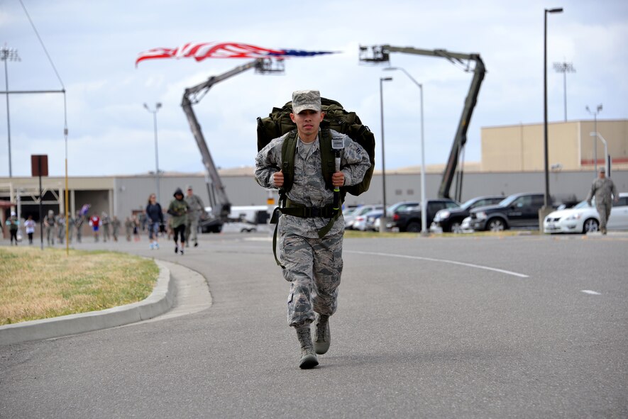 Airman 1st Class Josue Jimenez, 60th Security Forces Squadron, carries a 30-pound rucksack during the Gold Star Families Ruck March at Travis Air Force Base, Calif., May 21, 2016. The ruck march consisted of carrying a 30-pound rucksack for 6.2 miles around the installation. Each rucksack was filled with non-perishable food items which were donated to Mission Solano. (U.S. Air Force photo by Staff Sgt. Charles Rivezzo)