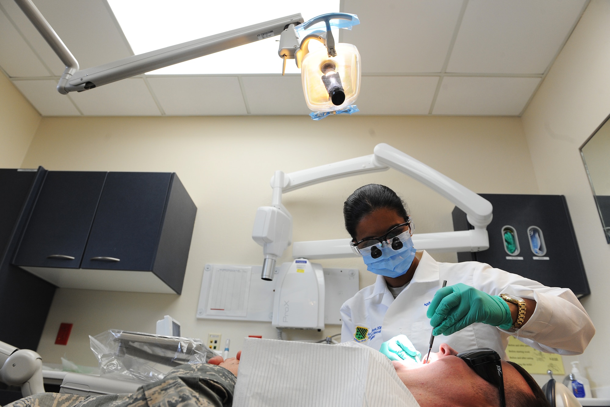 Maj. Anita Shade, 375th Dental Squadron dental residency program director, works on a patient May 17, 2016, and Scott Air Force Base, Illinois. Shade grew up in India before moving to the U.S., where she faced several challenges, including loneliness and poverty. After getting a job as a dental assistant, the owner of that practice helped her earn a U.S. dental license, and then she became a U.S. Air Force Airman.  (U.S. Air Force photo by Staff Sgt. Maria Bowman)