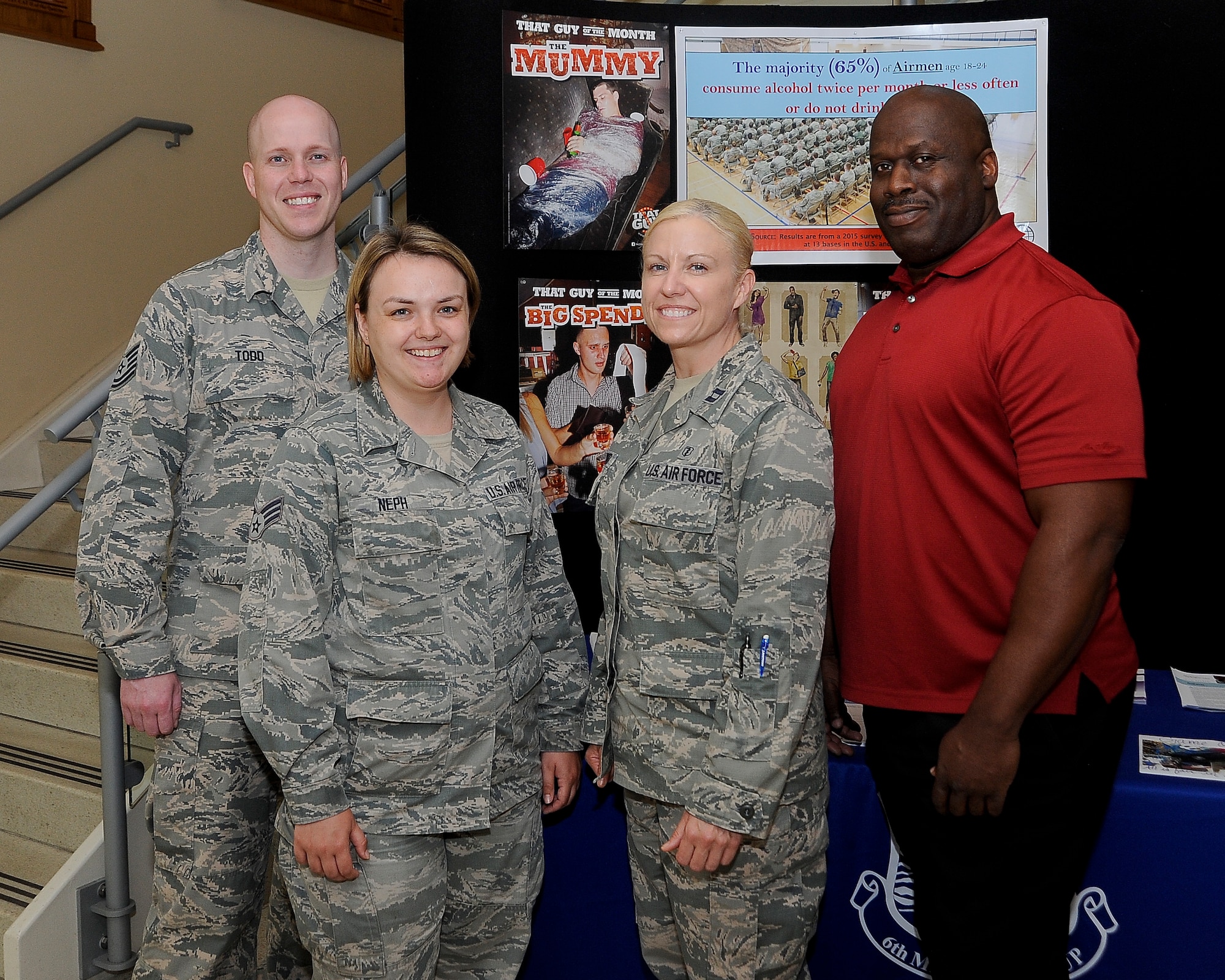 Alcohol and Drug Abuse Prevention and Treatment (ADAPT) members stand in front of an ADAPT display in the medical clinic at MacDill Air Force Base Fla., May 18, 2016. The ADAPT program provides prevention and treatment services for alcohol and substance abuse. (U.S. Air Force photo by Airman 1st Class Mariette Adams)