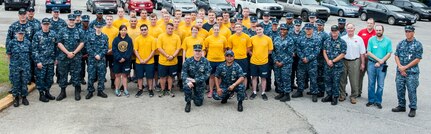 Sailors of the Naval Nuclear Power Training Unit Charleston community service division pose for a group photo with members of the Lowcountry Food Bank and the American Red Cross May 20, 2016, at Joint Base Charleston, S.C. More than 100 sailors transitioning through the community service division have volunteered nearly 10,000 hours in support of local nonprofit organizations since the program began October 2015. The program, created for sailors on hold from NPTU, awaiting orders due to medical, legal or other reasons, provides the opportunity to give back to the local community while resolving personal matters. The Lowcountry Food Bank and the American Red Cross presented the organization with letters of appreciation. (U.S. Air Force photo/Staff Sgt. Jared Trimarchi) 