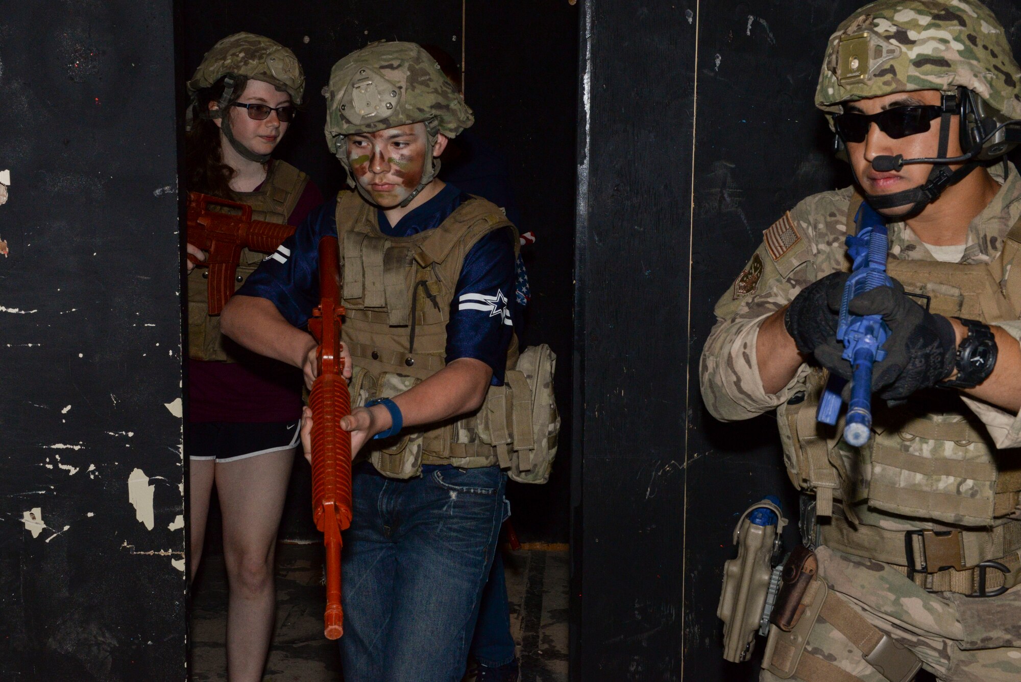 Airman 1st Class Justin Potter, a tactical response force member assigned to the 791st Missile Security Forces Squadron at Minot Air Force Base, N.D., demonstrates how to clear a room during Operation Heroes May 21, 2016. Operation Heroes was a simulated deployment, in which, children from the Minot AFB Youth Center experienced all aspects of a simulated deployment from pre-departure to securing a training site with the tactical response force team. (U.S. Air Force photo/Airman 1st Class Jessica Weissman)