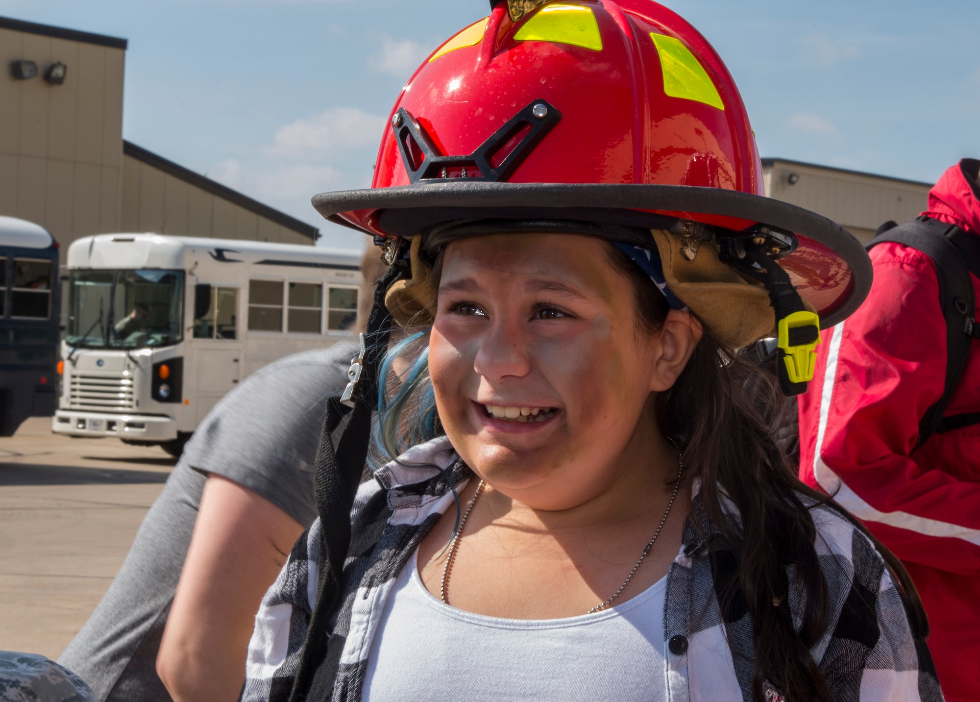 A Minot Youth Center member tries on a pilot’s helmet during operation heroes at Minot Air Force Base, N.D., May 21, 2016. During operation heroes, kids got to experience many different jobs of the Air Force such as pilots, security forces, maintenance and others. (U.S. Air Force photo/Airman 1st Class Christian Sullivan)