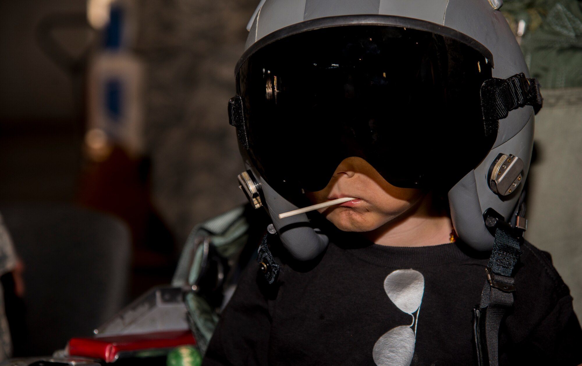 A Minot Youth Center member tries on a pilot’s helmet during operation heroes at Minot Air Force Base, N.D., May 21, 2016. During operation heroes, kids got to experience many different jobs of the Air Force such as pilots, security forces, maintenance and others. (U.S. Air Force photo/Airman 1st Class Christian Sullivan)