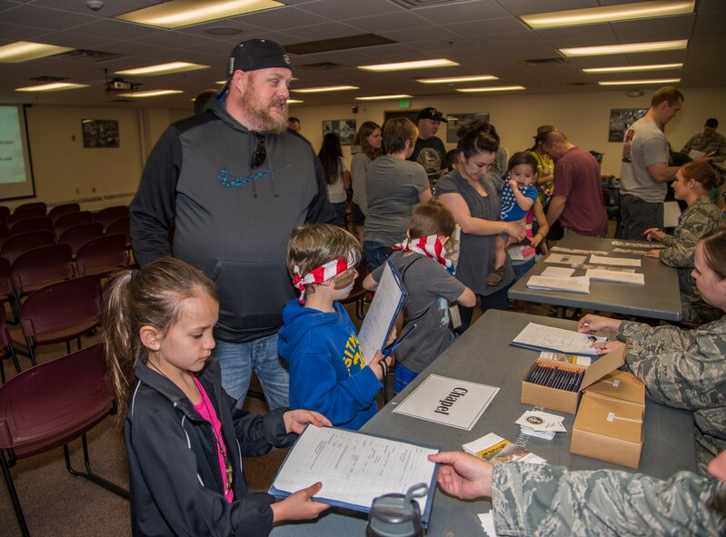 Minot Youth Center members go through an out-processing deployment line during operation heroes at Minot Air Force Base, N.D., May 21, 2016. During operation heroes, Minot AFB youth experience a simulated deployment to see what their parents go through. (U.S. Air Force photo/Airman 1st Class Christian Sullivan)