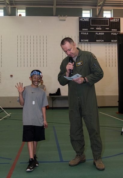 Col. David Ballew, 5th Bomb Wing vice commander, helps a Minot Youth Center member recite the warrior oath during Operation Heroes at Minot Air Force Base, N.D., May 21, 2016. During operation heroes, Minot AFB youth experience a simulated deployment to see what their parents go through. (U.S. Air Force photo/Airman 1st Class Christian Sullivan)
