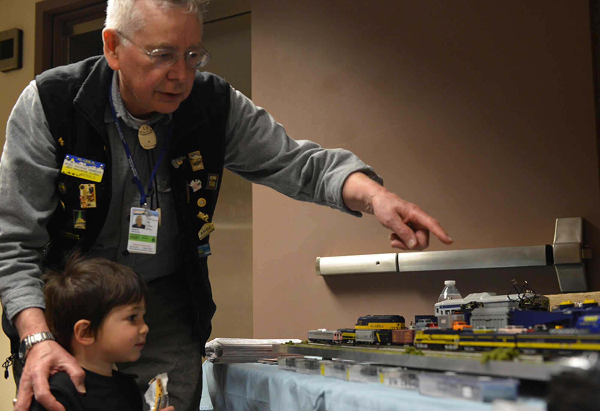 Gerald Forsyth, Military Society of Model Railroad Engineers public relations officer, teaches Ashton Rodriguez, 3, about the various model trains showcased at the 30th annual Retiree Appreciation Day event on Joint Base Elmendorf-Richardson, Alaska, May 21, 2016. This year’s event marked the first appearance of the Military Society of Model Railroad Engineers. (U.S. Air Force photo by Airman 1st Class Javier Alvarez)