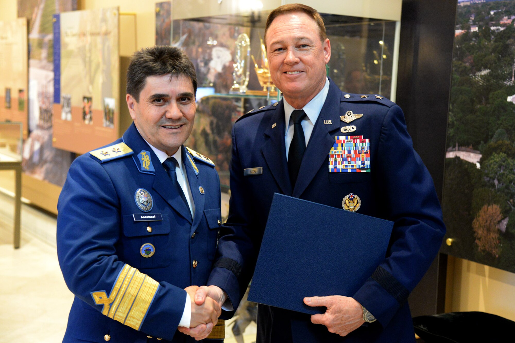 Maj. Gen. Laurian Anastasof, Chief of Air Staff of the Romanian Air Force,
is presented a memento by Air Force District of Washington Commander Maj.
Gen. Darryl Burke while visiting the Tomb of the Unknown Soldier for a
wreath laying ceremony at Arlington National Cemetery on May 24, 2016.
Distinguished visitors commonly pay formal respects to the sacrifice of
America's veterans in foreign wars by placing a wreath before the Tomb. The
Air Force District of Washington brings air, space and cyberspace
capabilities to the joint team protecting the nation's capital, and supports
local personnel and those serving worldwide. (U.S. Air Force Photo/Tech. Sgt. Matt Davis)

