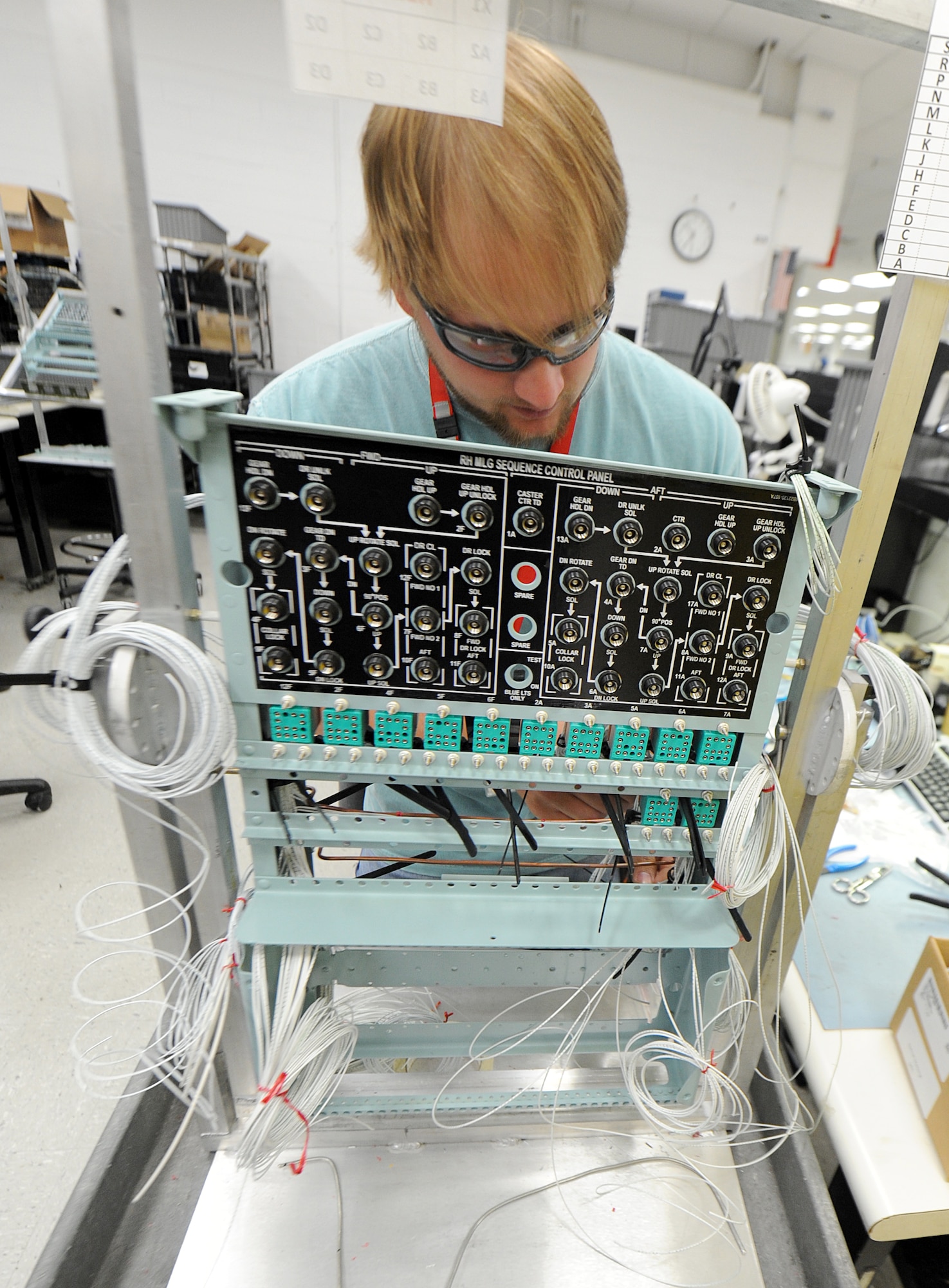 Brandon Deal, 402nd Electronics Maintenance Group senior avionics technician, performs work on a C-5 main landing gear sequence control panel. (U.S. Air Force photo byTommie Horton)