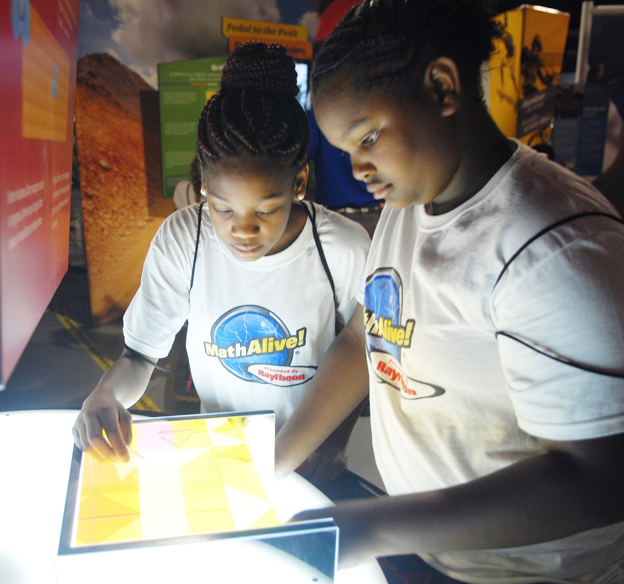 Moniquca Mangham (right) and Zeniah Holder, Daughtry Elementary School 5th graders, play Tessellations to match the repeating patterns without overlapping at MathAlive!, 
May 19. Fifth graders from Daughtry Elementary School, Jackson, Georgia, were the first ones to visit the Museum of Aviation’s newest exhibit.. (U.S. Air Force photo by Misuzu Allen)