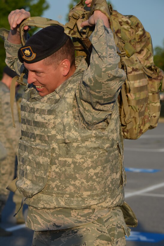 Maj. IanWalker, 78th Security Forces Squadron commander, pulls on his ruck sack as he
prepares for the 2.3-mile Fallen Defenders memorial ruck march May 16. (U.S. Air Force photo by Kenya Askew)