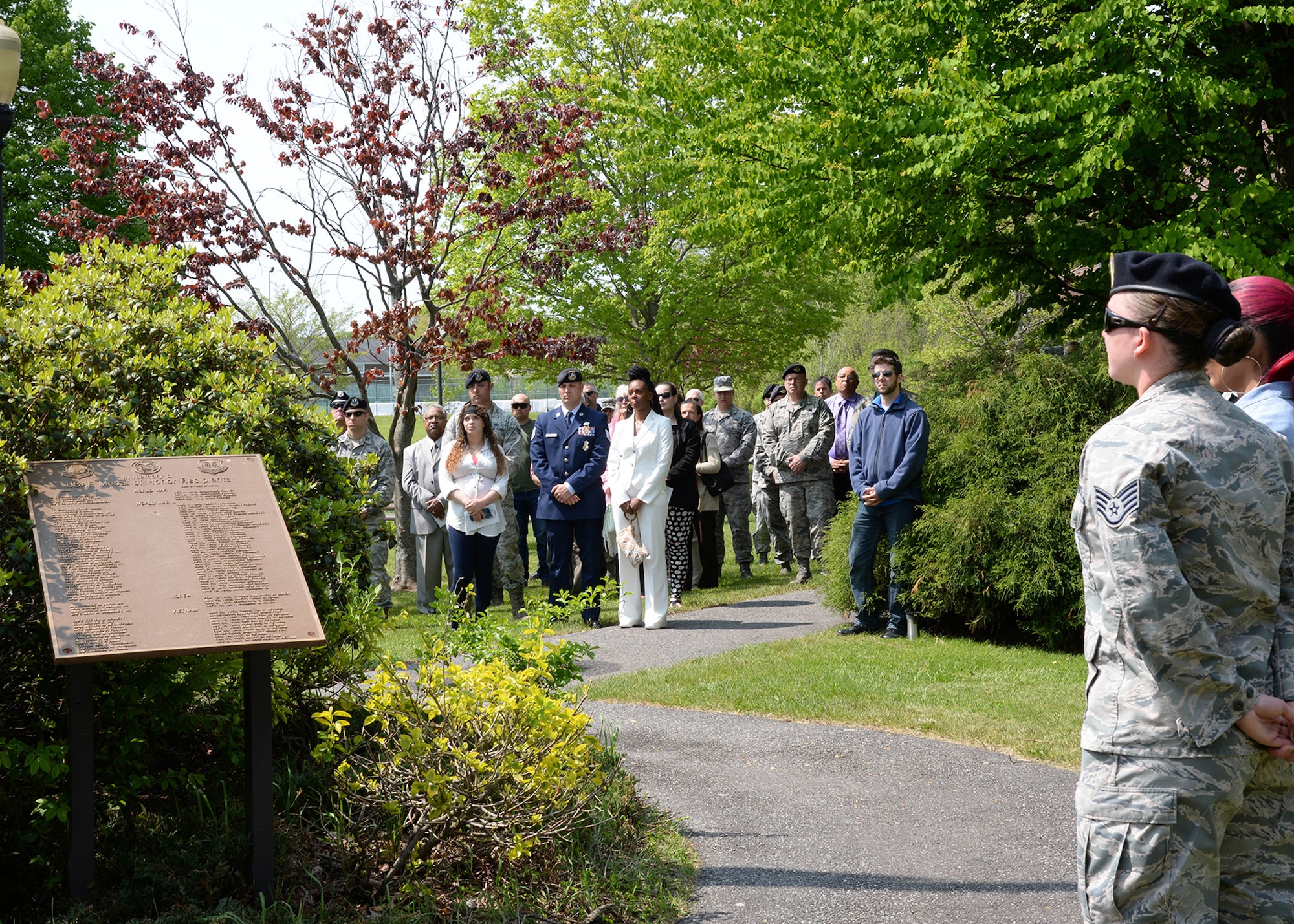 Members of the base community watch as a flag is raised in memory of three former Hanscom personnel at a Memorial Park dedication ceremony May 20. The ceremony recognized Peter B. “Pistol Pete” Bousquet, Senior Airman Kcey E. Ruiz and Senior Airman Nathan C. Sartain with a tree and bronze plaque dedicated in their memory. (U.S. Air Force photo by Linda LaBonte Britt)
