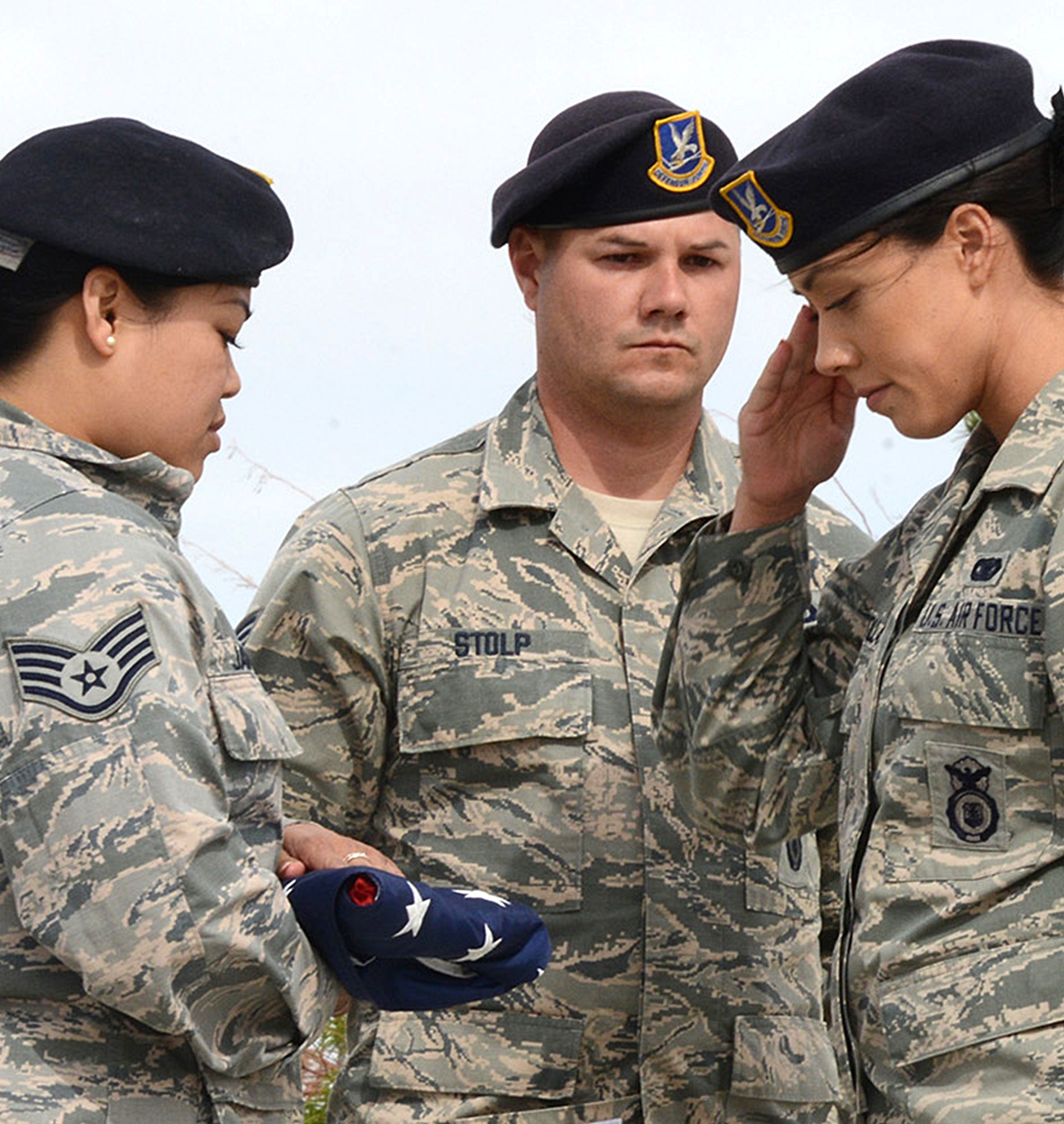 Staff Sgt. Cinderella James, Staff Sgt. Tylor Stolp, and Senior Airman Savanna Santillan,  412th Security Forces Squadron, salute the American Flag during a special retreat ceremony marking the end of Police Week. (U.S. Air Force photo by Christopher Ball.)