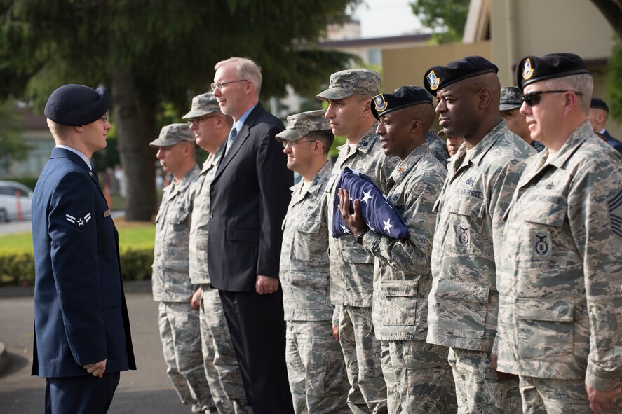 Maj. Tyrone Bess, 374th Security Forces Squadron commander, folds the U.S. Flag during a retreat ceremony May 19, 2016 at Yokota Air Base, Japan. The security forces-lead ceremony wrapped up the squadron’s National Police Week activities while also mourning their fallen Military Working Dog Alan/L220 who recently passed away from cancer. (U.S. Air Force photo by Yasuo Osakabe/Released)