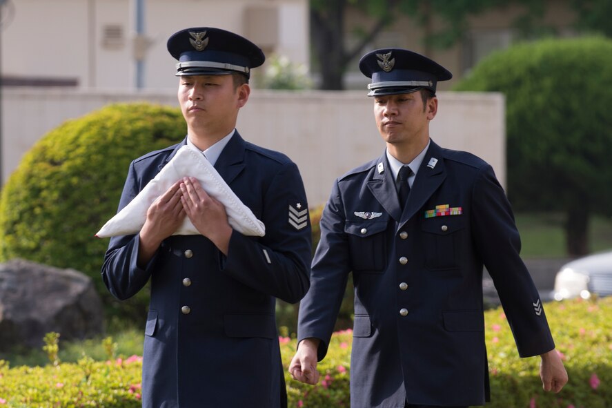Japan Air Self-Defense Force members from the Operations Support Wing carry the Japanese Flag during a retreat ceremony May 19, 2016 at Yokota Air Base, Japan. JASDF counterparts also participated in the National Police Week events. (U.S. Air Force photo by Yasuo Osakabe/Released)   