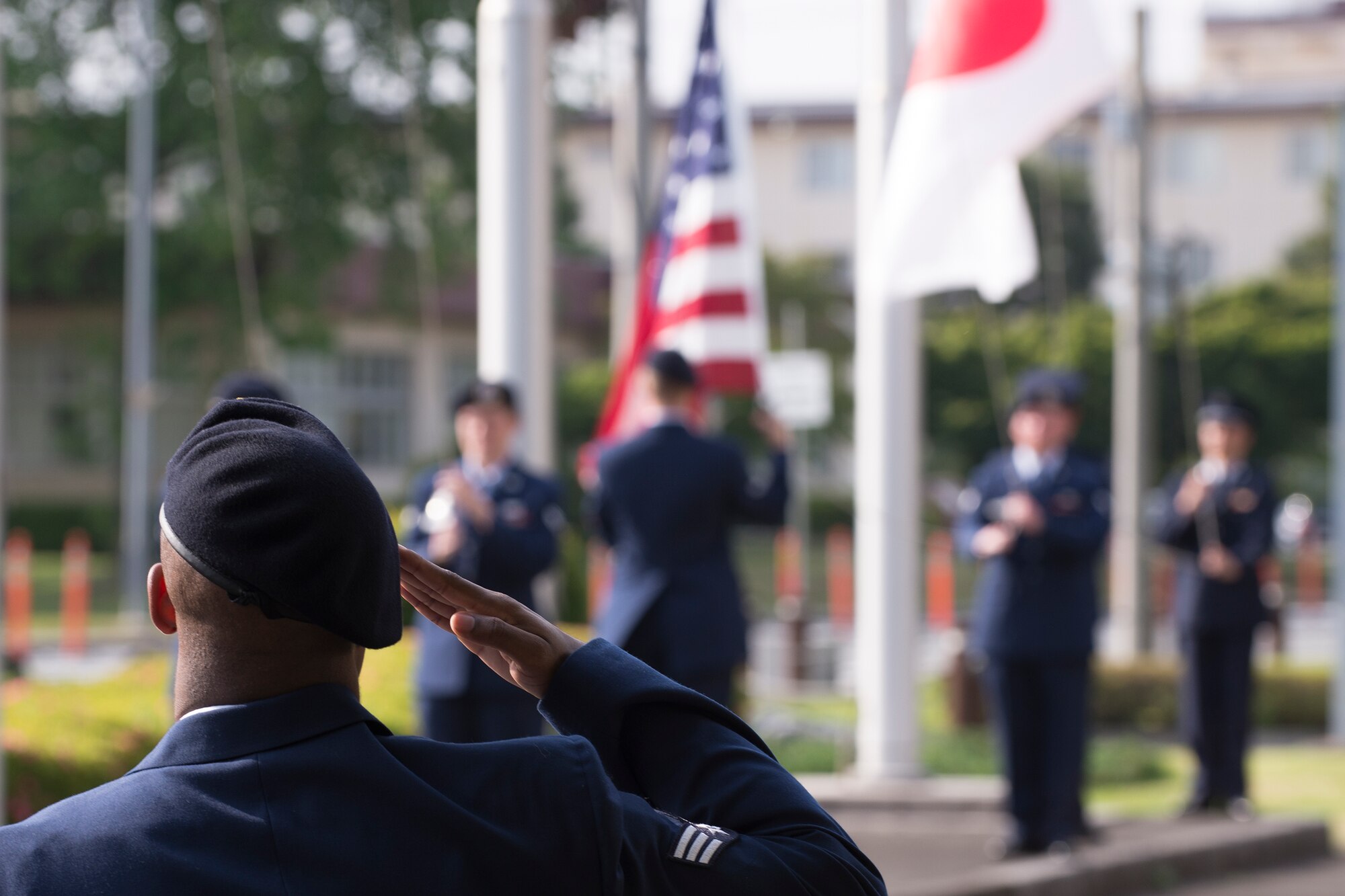 An Airman with the 374th Security Forces Squadron salutes during a retreat ceremony May 19, 2016 at Yokota Air Base, Japan. The security forces-lead ceremony wrapped up the squadron’s National Police Week activities while giving them the opportunity to mourn their fallen Military Working Dog Alan/L220 who recently passed away from cancer. (U.S. Air Force photo by Yasuo Osakabe/Released)