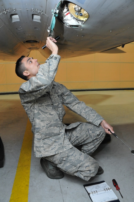 Staff Sgt. Trevor Tompkins of the Massachusetts Air National Guard, 104th Fighter Wing, inspects an F-15 Eagle aircraft during his daily preflight checks at Barnes Air National Guard Base. Tompkins was selected as the Continental U.S. North American Aerospace Control Alert Maintainer of the Year out of 16 ACA units throughout the Air Force. (U.S. Air National Guard photos by Master Sgt. Julie Avey) 
