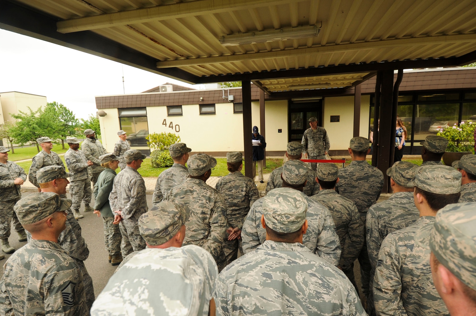 U.S. Air Force Col. Joe McFall, 52nd Fighter Wing commander, center, speaks to Airmen during the grand opening of the Saber Pet Lodge at Spangdahlem Air Base, Germany, May 23, 2016. McFall highlighted the collective efforts of the 52nd Civil Engineer Squadron and the 52nd Force Support Squadron in making the facility a reality. (U.S. Air Force photo by Staff Sgt. Joe W. McFadden/Released)