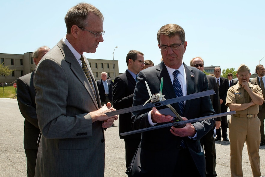 Defense Secretary Ash Carter, right, examining an unmanned aerial vehicle.