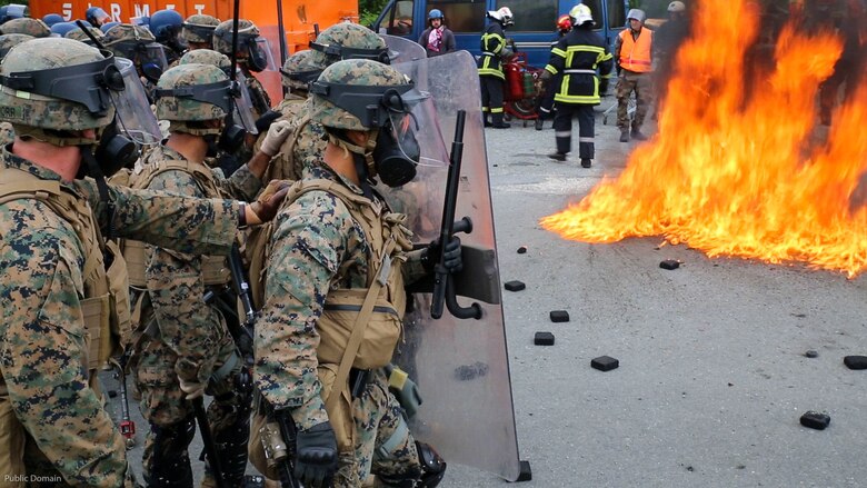 U.S. Marines with Special Purpose Marine Air-Ground Task Force-Crisis Response-Africa form a wall of shields alongside French Gendarmes as a Molotov cocktail explodes near their feet at the National Gendarmerie Tactical Training Center in Saint-Astier, France, May 13, 2016. The Marines worked closely with the French National Gendarmerie, exchanging riot-control techniques for possible real-world scenarios at embassies around Europe and Africa. 