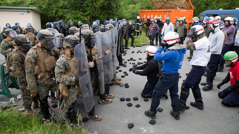 U.S. Marines and members of the French National Gendarmerie form a wall of shields to protect a simulated U.S. Embassy during a riot-control exercise at the National Gendarmerie Training Center in St. Astier, France, May 13, 2016. Marines with Special Purpose Marine Air-Ground Task Force-Crisis Response-Africa worked closely with their French counterparts to exchange riot-control techniques while for possible real-world scenarios at embassies around Europe and Africa. 