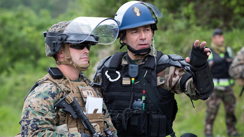 U.S. Marine Corps 1st Lt. Nicholas Berger, a platoon commander with Special Purpose Marine Air-Ground Task Force-Crisis Response-Africa, and Maj. Benoît Fief, tactical group commander with the French National Gendarmerie, discuss the upcoming training scenario during a riot-control exercise at the National Gendarmerie Training Center in St. Astier, France, May 13, 2016. This exercise helped reinforce the strong relationship between the United States and France and prepare the Marines and Gendarmes to work together in possible real-world scenarios at embassies around Europe and Africa. 