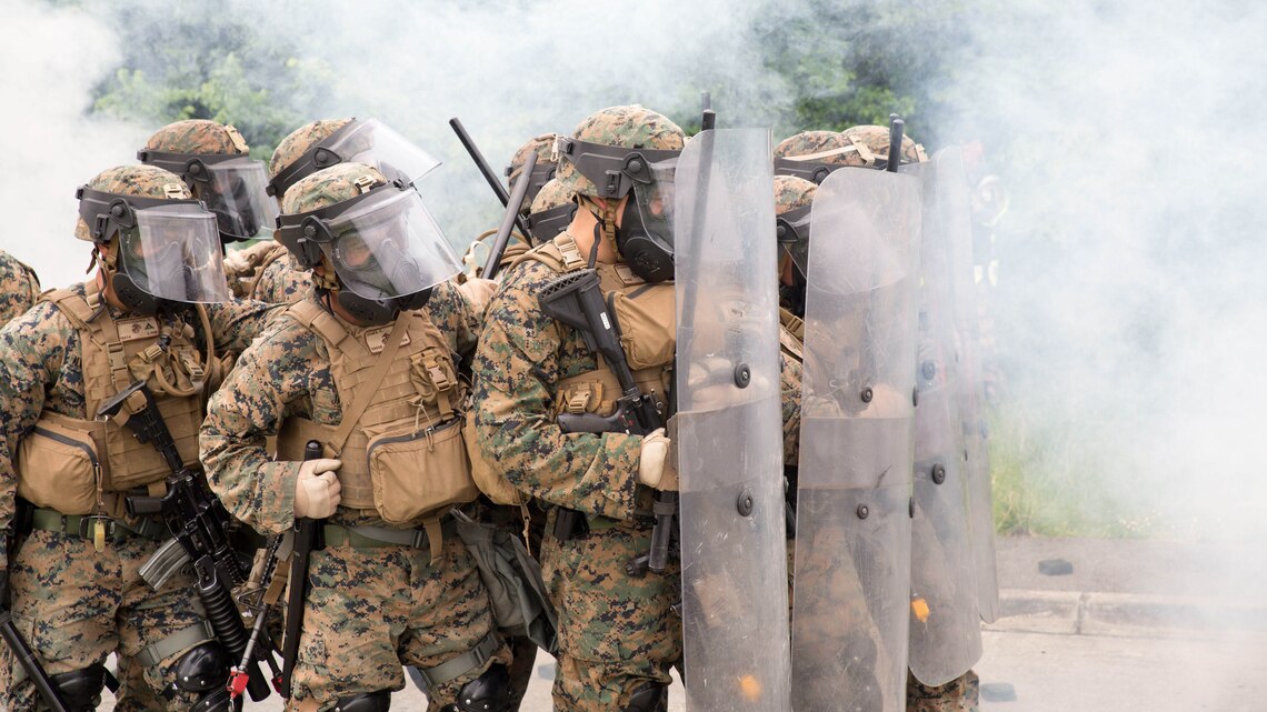 U.S. Marines with Special Purpose Marine Air-Ground Task Force-Crisis Response-Africa form a wall of shields to protect a simulated U.S. Embassy during a riot-control exercise at the National Gendarmerie Training Center in St. Astier, France, May 13, 2016. The Marines trained alongside the French National Gendarmerie to operate through dense smoke and CS gas while maintaining tightly organized formations. 