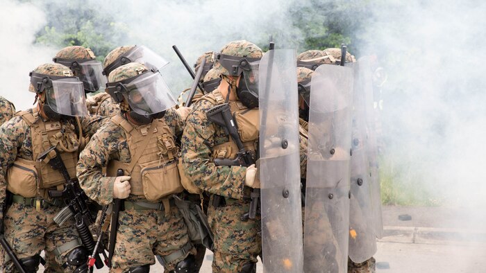 U.S. Marines with Special Purpose Marine Air-Ground Task Force-Crisis Response-Africa form a wall of shields to protect a simulated U.S. Embassy during a riot-control exercise at the National Gendarmerie Training Center in St. Astier, France, May 13, 2016. The Marines trained alongside the French National Gendarmerie to operate through dense smoke and CS gas while maintaining tightly organized formations. 