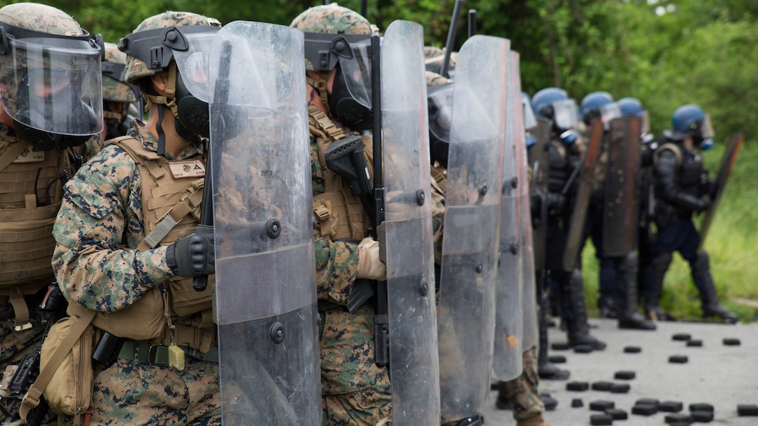 U.S. Marines with Special Purpose Marine Air-Ground Task Force-Crisis Response-Africa form a wall of shields alongside members of the French National Gendarmerie to protect a simulated U.S. Embassy during a riot control exercise at the National Gendarmerie Training Center in St. Astier, France, May 13, 2016. This exercise helped reinforce the strong relationship between the United States and France and prepared the Marines and Gendarmes to work together in possible real-world scenarios at embassies around Europe and Africa. 