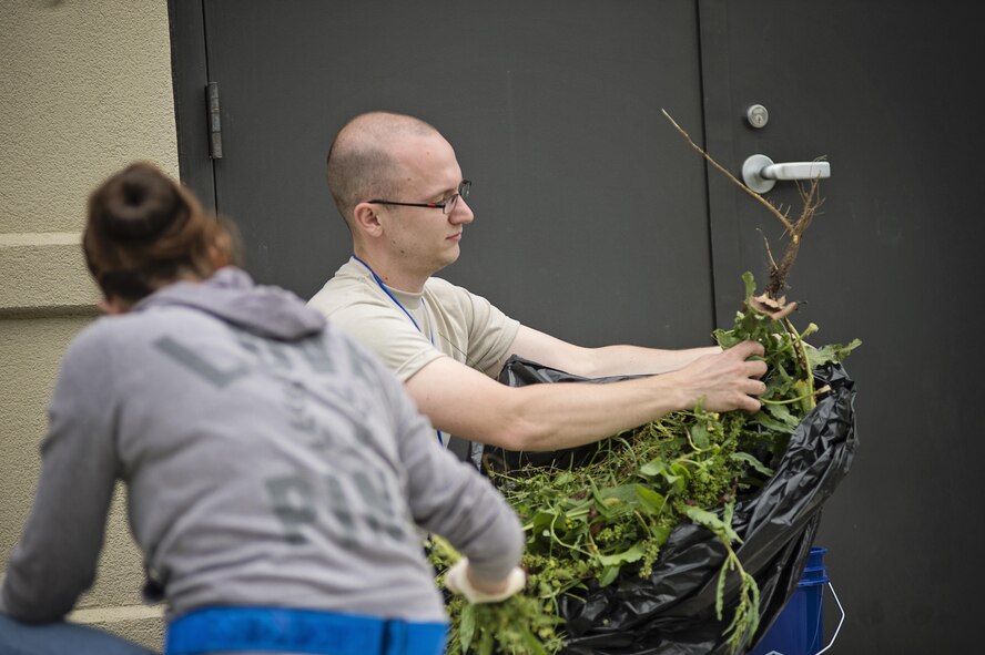 Members of the 512th Airlift Wing's Developmental & Training Flight clean up the playground at the Child Development Center on Dover Air Force Base, Del., May 21, 2016, during the wing's Unit Training Assembly. The D&TF is a unit that trains future reservists on what to expect during Basic Military Training and an overview of Air Force culture. (U.S. Air Force photo/Capt. Bernie Kale)
