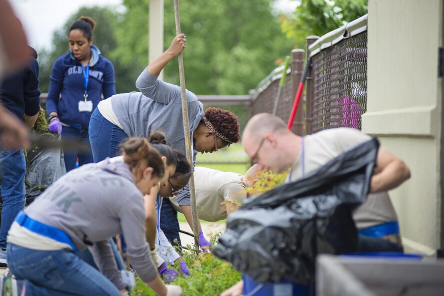 Members of the 512th Airlift Wing's Developmental & Training Flight clean up the playground at the Child Development Center on Dover Air Force Base, Del., May 21, 2016, during the wing's Unit Training Assembly. The D&TF is a unit that trains future reservists on what to expect during Basic Military Training and an overview of Air Force culture. (U.S. Air Force photo/Capt. Bernie Kale)